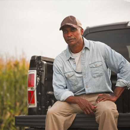 Flexible Ag Banking farmer sitting in the back of truck