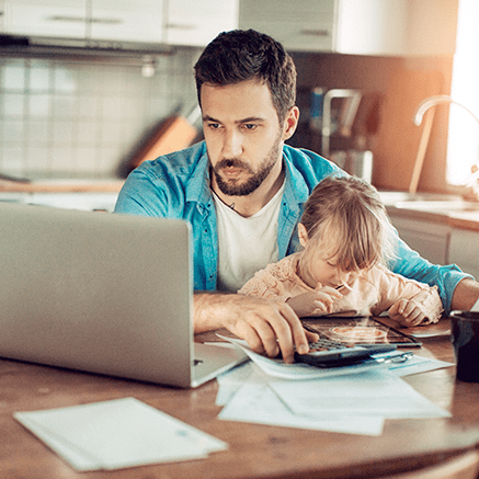 Perfect for Individuals or Families with: man working at table with daughter on lap