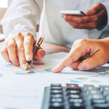 Customized Cash Management Solutions hands pointing to graphs on chart