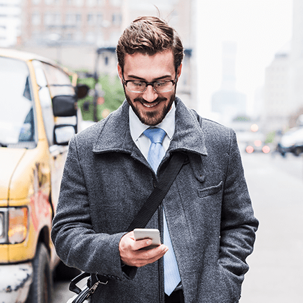 Proactive Fraud Management business man on busy street looking at phone