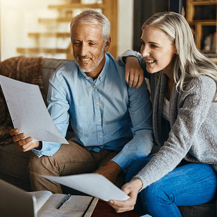 Choose Your Next Step: couple sitting on couch looking at retirement plan