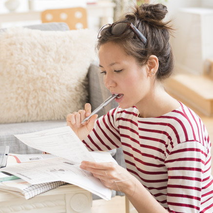 Online Banking woman looking at loan papers