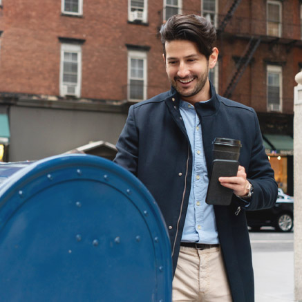 By Mail man putting letter in drop box