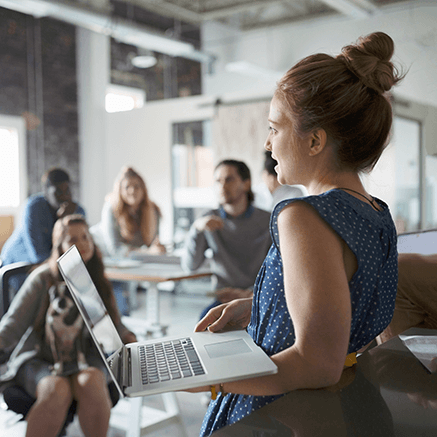 Group Retirement Plans woman on laptop presenting to team